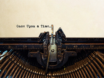 A typewriter with typed words on a page: Once Upon a Time...