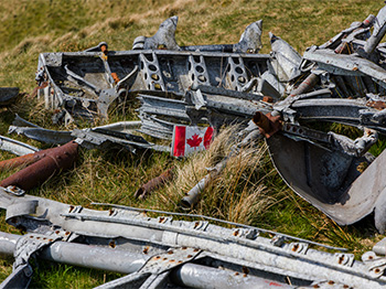 Wreckage of a Royal Canadian Air Force Wellington bomber with Canada flag.