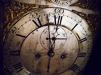 Clock face with Roman numerals chiming twelve