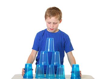 boy stacking cups