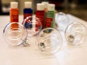 Bottles of paint and clear ornaments