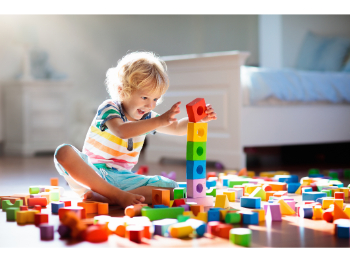 Toddler playing with colourful blocks