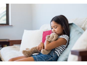 a child holds a stuffed animal