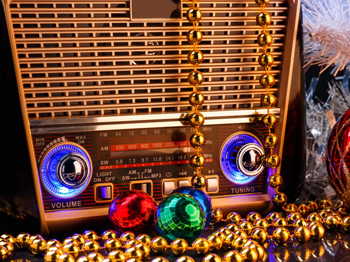 A retro style radio with Christmas shiney decorations.