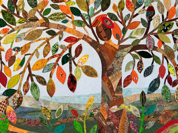A colourful quilt with a tree any many leaves.