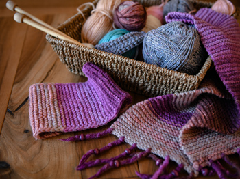 Colourful knitting accessories in a basket.