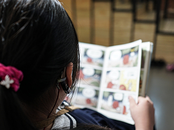 Child reading a comic book.