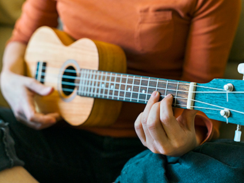 A person playing a ukulele.
