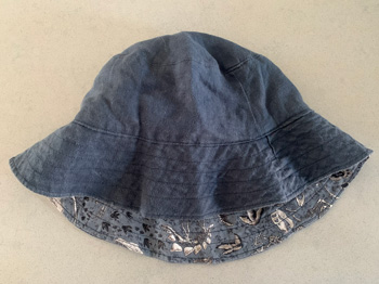 A bucket hat with its interior and exterior fabric exposed.