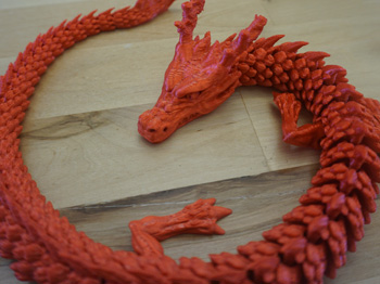 A red 3D-printed dragon.