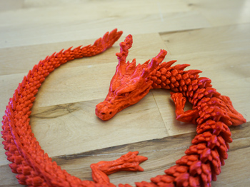 A red 3D printed dragon.