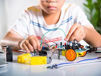 Child building mechanical toys