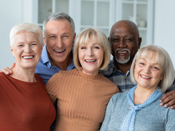 A group of older adults smiling in a group portrait.