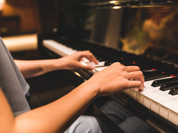 Person playing a piano.