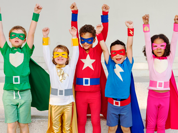 Group of five children dressed in colourful super hero outfits with caps and eye masks.