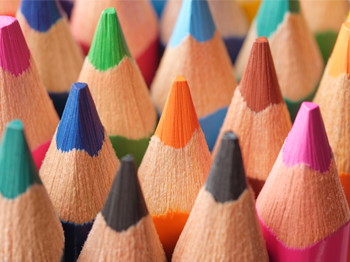 A close-up photograph of brightly coloured pencil crayons