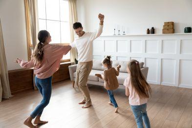 Family dancing in their living room