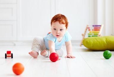 a baby plays with colourful toys