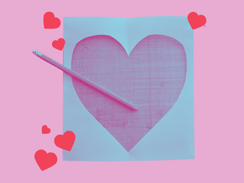 A paper heart on a pink background. 