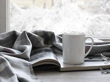 Mug and book with blanket