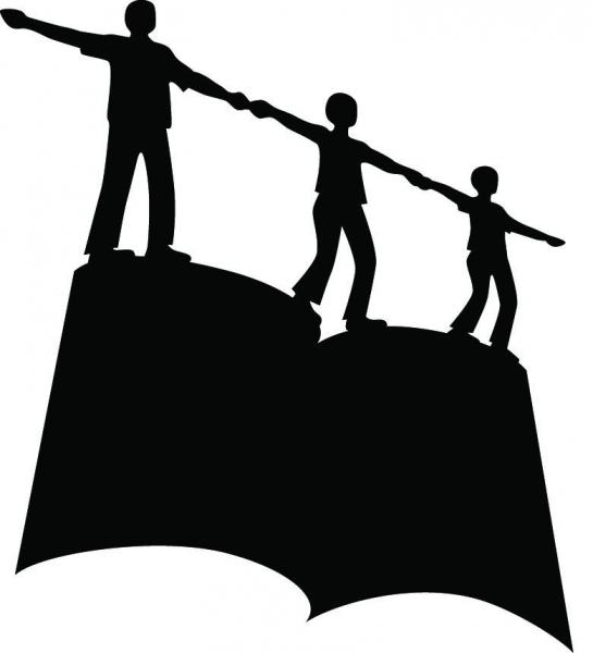 A silhouette of three figure holding hands atop a large book